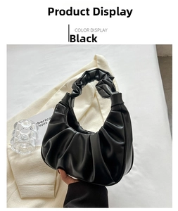 Detail shot of black ruched cloud bag showing soft PU leather texture and pleated handle