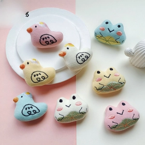 Close-up of cute plush animal patches with detailed embroidery on soft cartoon fabric