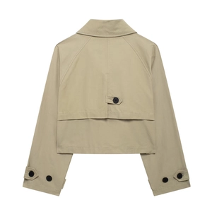 Detail view of the back windproof panel and button strap on khaki cropped trench jacket