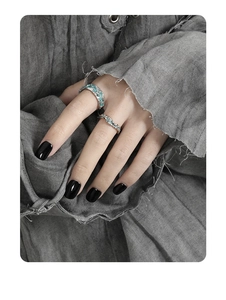 Detailed close-up of s925 silver rings set with turquoise enamel on model's hand
