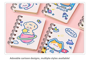 Close-up of cute cartoon astronaut spiral notebooks with space illustrations on pink background