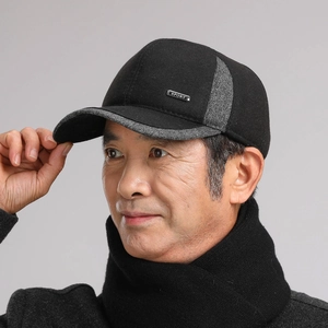 Detail of winter baseball cap with metal SPORT badge and warm wool blend fabric
