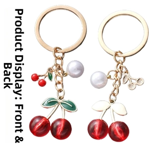 Detailed front and back view of red translucent cherry keychain with gold metal ring