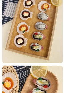 Macro view of realistic faux scallops and oysters on wooden plate with lemon slices