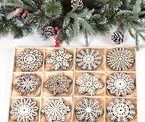 Detailed view of 12 unique laser-cut wooden snowflake ornaments in a storage box