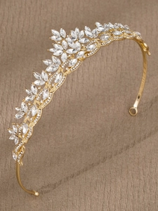 Detailed close-up of golden bridal tiara with sparkling crystal rhinestones and leaf motifs