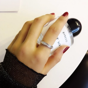 Macro shot of a silver titanium steel ring with sparkling square-cut cubic zirconia row inlay