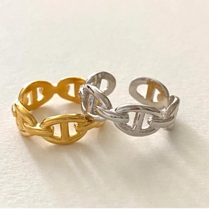Macro shot of silver and gold anchor chain rings with a polished mirror finish detail