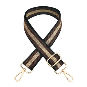 Close-up of adjustable striped handbag strap in brown and gold with metal snap hooks