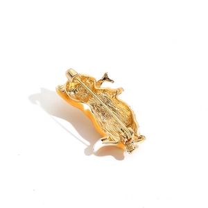 Cute enamel cat brooch with orange details and a secure gold metal safety pin back