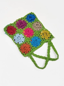 Detail of colorful crochet shoulder bag with intricate floral patchwork and cotton texture