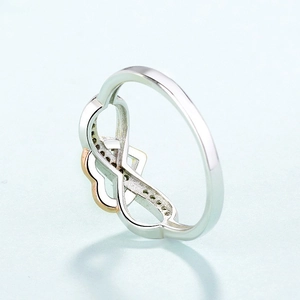 Detail of silver and rose gold ring with infinity heart design and pavé stones