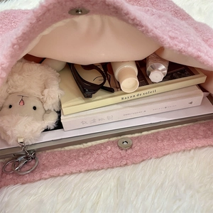Interior view of pink fuzzy tote bag showing large capacity for books and tablet