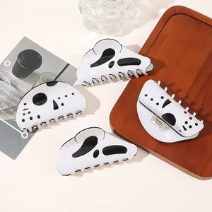 Macro shot of minimalist black and white hair clips on a tray with spring mechanism detail