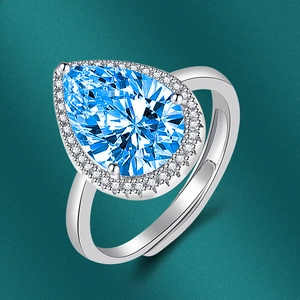 Detailed view of silver adjustable ring with pear-shaped blue stone and halo crystals
