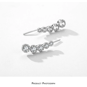 Close-up of curved S925 sterling silver earrings with five gradient cubic zirconia stones