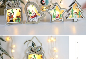 Detail of wooden LED Christmas ornaments featuring house and star shapes with warm light