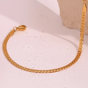 Close-up of 18K gold plated stainless steel flat curb chain bracelet with water droplets