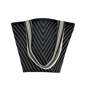 Knit shoulder tote bag with black and white chevron pattern and striped handles