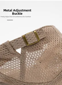 Detailed macro view of the vintage gold metal adjustment buckle on the mesh sun hat