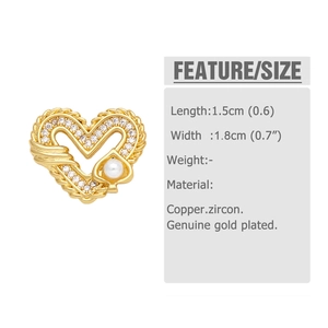 Macro detail of heart-shaped gold-plated copper earring with pearls and zircons