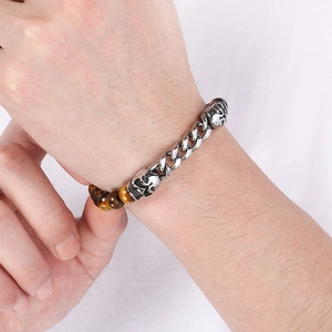Close-up of men's tiger eye bead bracelet with stainless steel skull and cuban chain