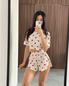 Close-up of summer loungewear set featuring red heart patterns and elastic waistband