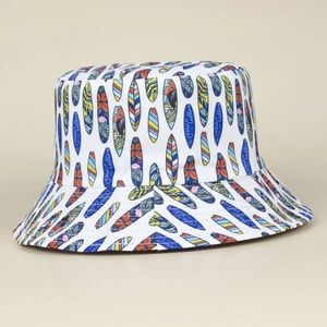 White canvas bucket hat with colorful surfboard prints and Ocean Calling typography