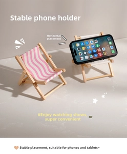 Macro shot of pink striped folding mini beach chair phone holder with wood frame