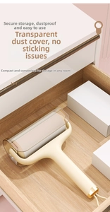 Detail view of the lint roller with transparent dust cover and cream handle in a drawer