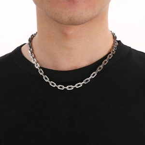 Detail of a 7/9mm silver titanium steel box chain necklace worn by a male model
