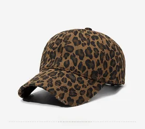 Detailed close-up of distressed brim on leopard print cotton baseball cap with retro style
