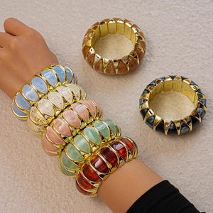 Detailed close-up of wide stretch resin bracelets featuring gold frames and vibrant colors