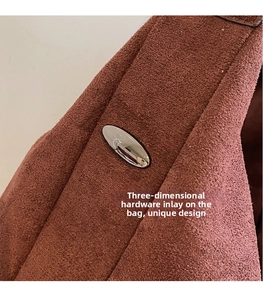 Macro shot of silver oval metal hardware on vintage tan frosted leather tote bag