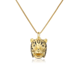 Detailed macro shot of 18K gold plated leopard pendant with black enamel dots and box chain