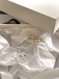 Irregular lava style rings in gold and silver finish placed in a gift box packaging