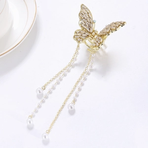 Elegant gold butterfly hair claw with sparkling crystals and hanging pearl tassels