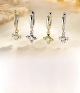 Detail view of coffee gold and silver cross earrings with zircon inlays and sizing chart
