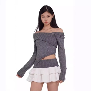 Off-shoulder grey knit crop top paired with a white pleated mini skirt on model