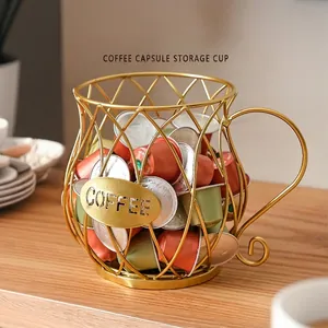Gold wire mesh coffee pod holder in cup shape with COFFEE label on wooden table