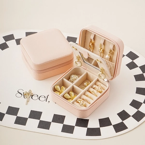 Portable pink jewelry organizer box with mirror and zipper closure for travel storage