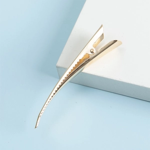 Minimalist gold-brushed eagle beak metal hair clip with a clean and elegant design