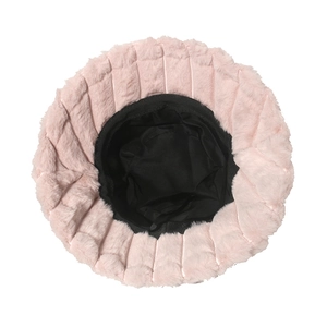 Detail view of pink fuzzy bucket hat showing soft plush texture and black twill lining