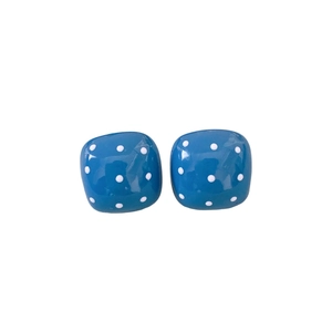 Minimalist square blue earrings with white polka dots on a clean white background