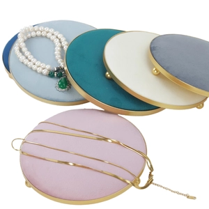 Close-up of velvet jewelry display trays with gold metal frames in various colors