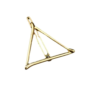 Minimalist golden geometric triangle hair clip with polished metallic finish on white backdrop