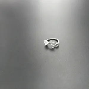 Detailed close-up of a silver twig ring featuring white flowers and leaf-shaped crystals