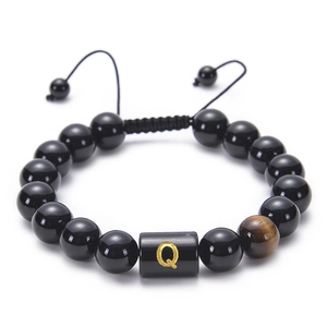 Detail of adjustable obsidian bead bracelet featuring a tiger eye stone and golden letter Q