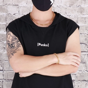 Detailed shot of golden hip hop style thick Cuban chain necklace and bracelet on model