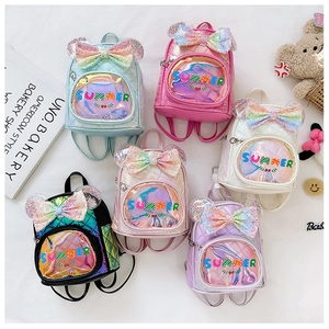 Detail of glittery bow and sequins on various colorful princess backpacks for girls